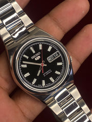 Seiko 5 SNKC55J1 — Black Dial, Red Seconds, Exhibition Caseback | Ref- 7S26-02P0.