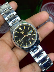 Seiko 5 Automatic — Black & Gold Dial Watch with Exhibition Back | Ref 7S26-01T0.