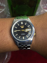 Seiko 5 SNKF67J1 Automatic — Black Sunburst Dial Watch with Exhibition Back | Ref 7S26-00X0.