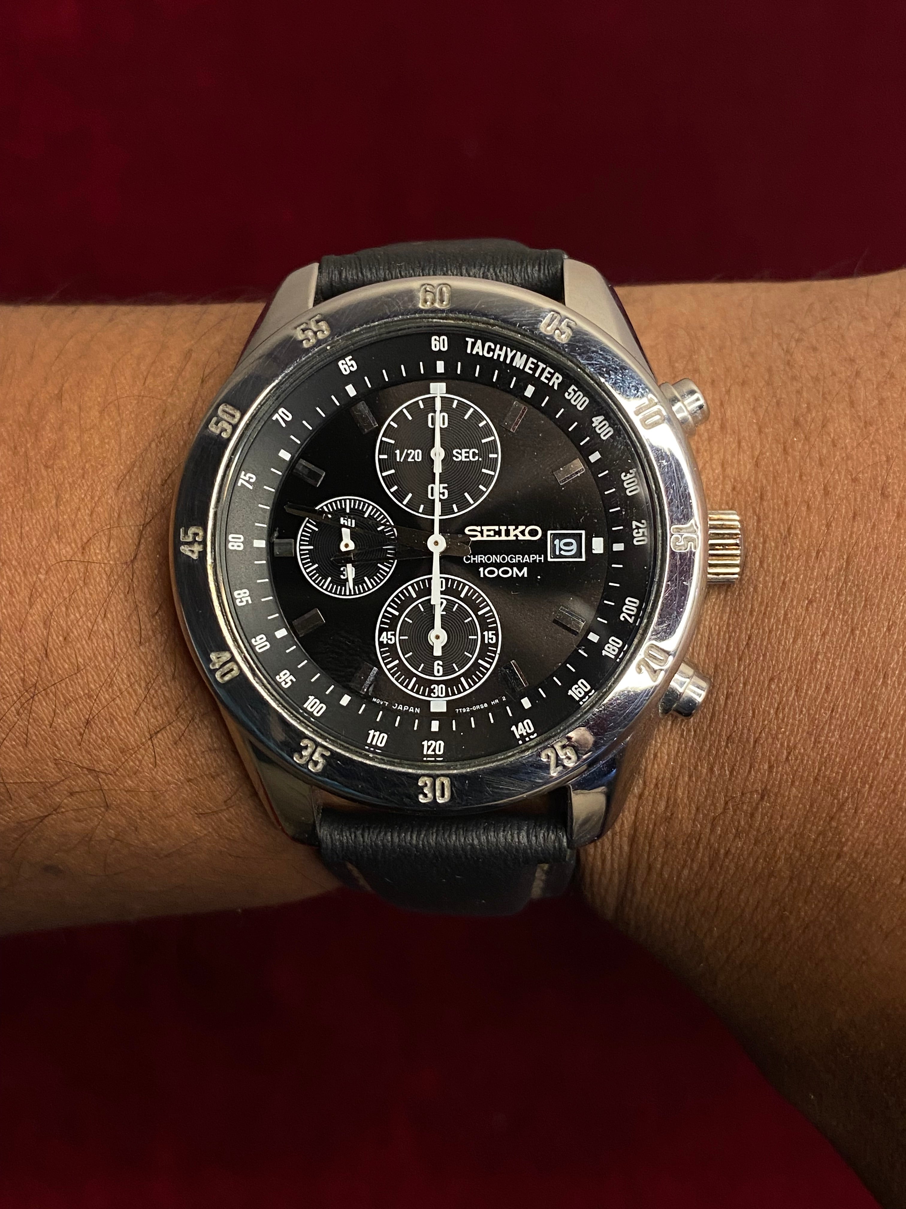 Seiko 7T92 Chronograph — Black Dial with three sub-dials and a black leather strap.

100m water resistance.