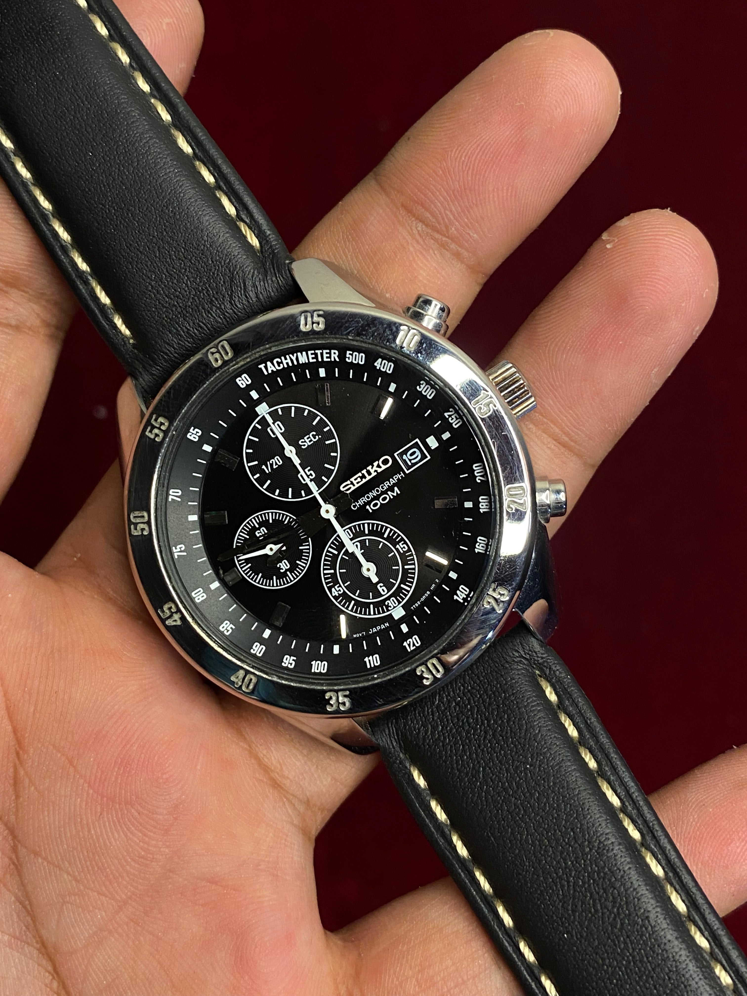 Seiko 7T92 Chronograph — Black Dial with three sub-dials and a black leather strap.

100m water resistance.