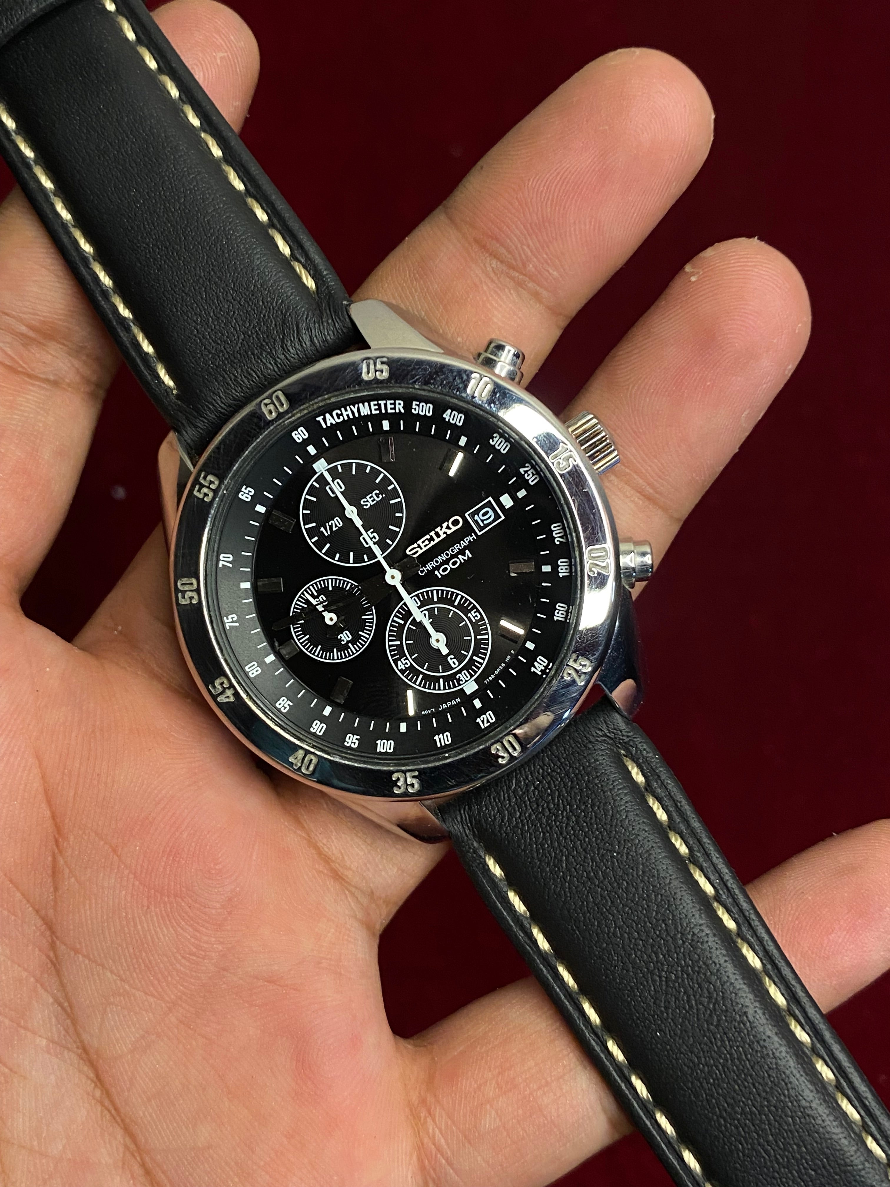 Seiko 7T92 Chronograph — Black Dial with three sub-dials and a black leather strap.

100m water resistance.