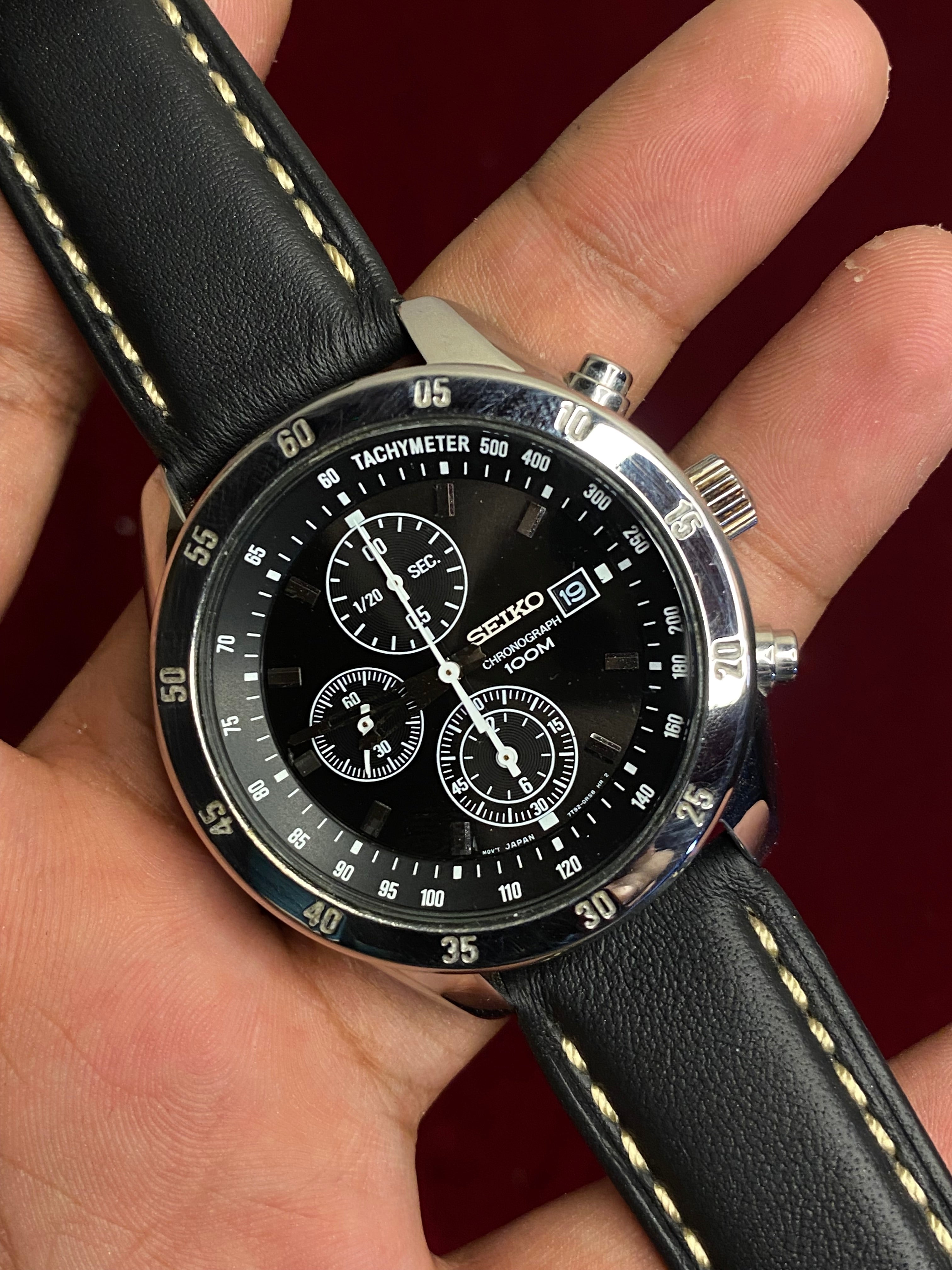 Seiko 7T92 Chronograph — Black Dial with three sub-dials and a black leather strap.

100m water resistance.